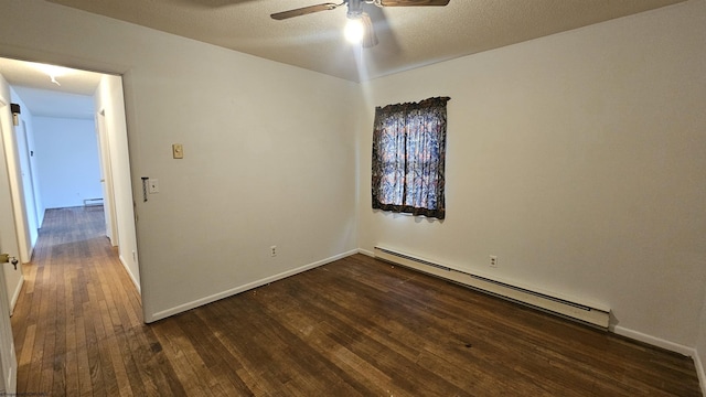 spare room with baseboards, a baseboard radiator, ceiling fan, dark wood-type flooring, and a textured ceiling