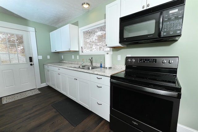 kitchen with black appliances, dark wood-type flooring, white cabinets, and a sink