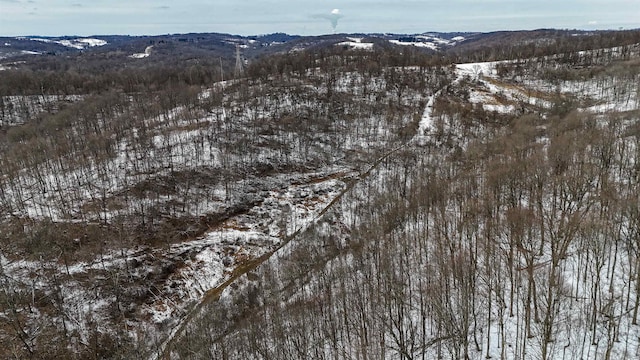 snowy aerial view featuring a mountain view