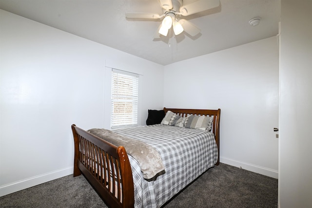 bedroom featuring dark colored carpet, a ceiling fan, and baseboards