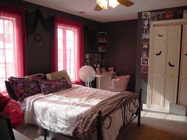 carpeted bedroom with ceiling fan and visible vents