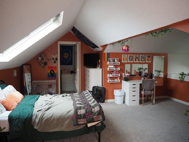 carpeted bedroom with lofted ceiling with skylight and baseboards