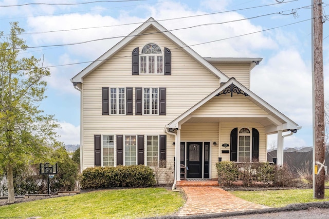 traditional-style house featuring a front lawn and a porch