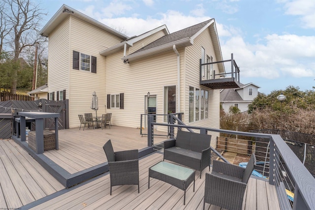 wooden terrace featuring outdoor dining area and outdoor lounge area