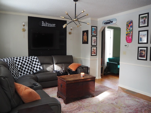 living area featuring crown molding, a textured ceiling, and wood finished floors