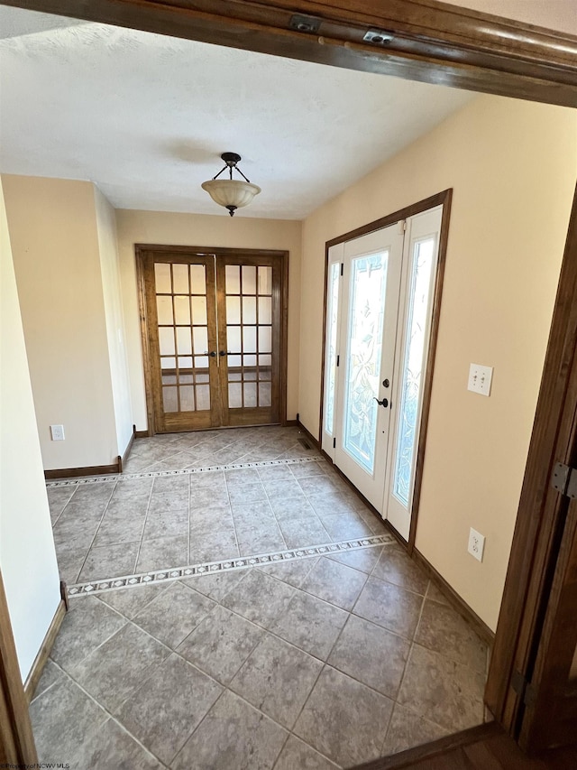 doorway to outside with light tile patterned floors, french doors, and baseboards