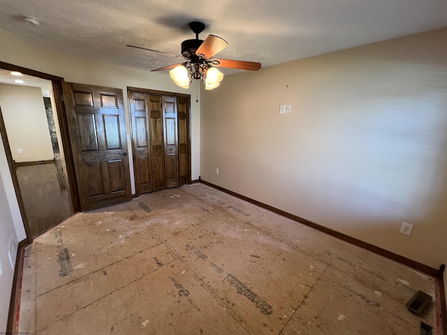 unfurnished bedroom featuring baseboards and a ceiling fan