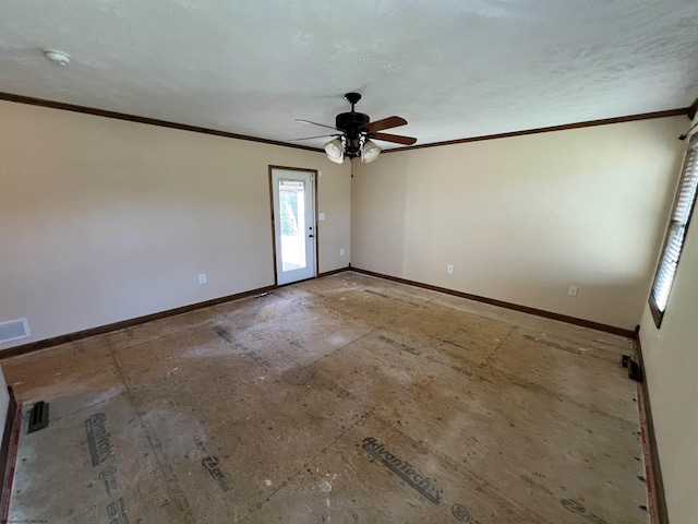 spare room featuring crown molding, baseboards, and ceiling fan