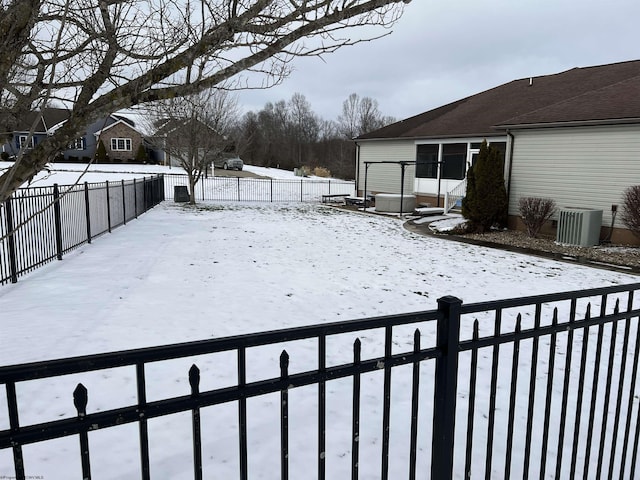 snowy yard with fence private yard and central air condition unit