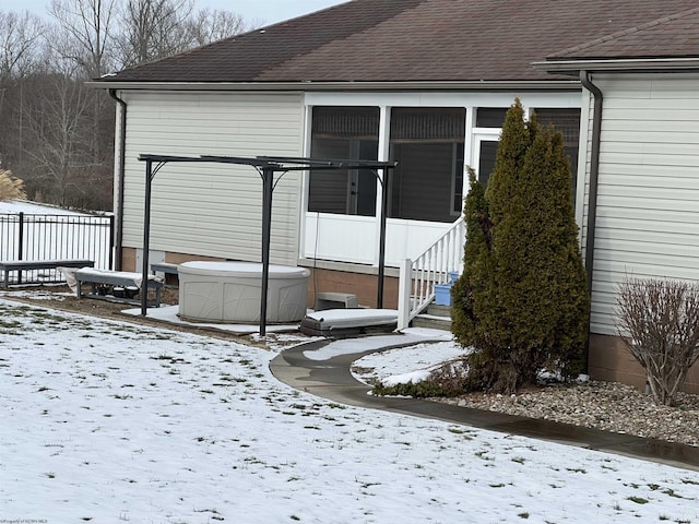 exterior space with fence and roof with shingles