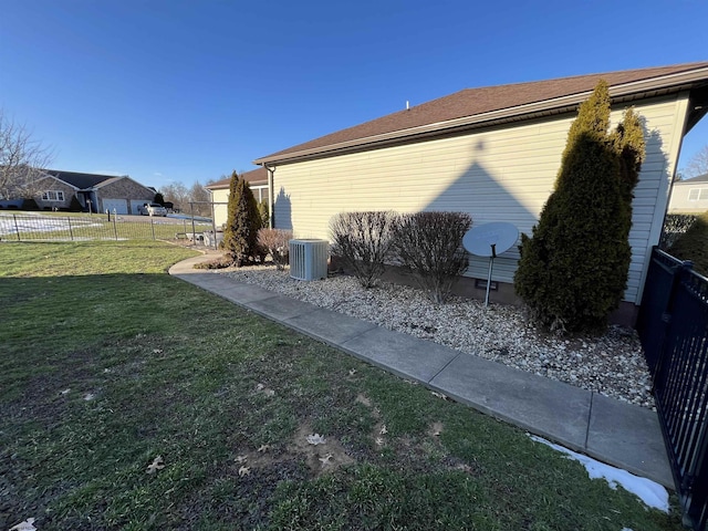 view of property exterior featuring a yard, cooling unit, and a fenced backyard