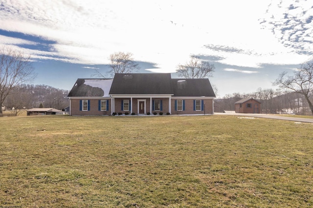 view of front of house featuring brick siding and a front lawn