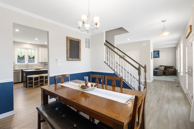 dining area with recessed lighting, visible vents, light wood-style floors, stairs, and an inviting chandelier