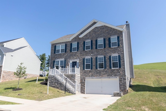 colonial inspired home with a garage, concrete driveway, a chimney, stairway, and a front lawn