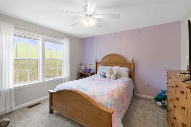 bedroom with baseboards, visible vents, ceiling fan, and light colored carpet