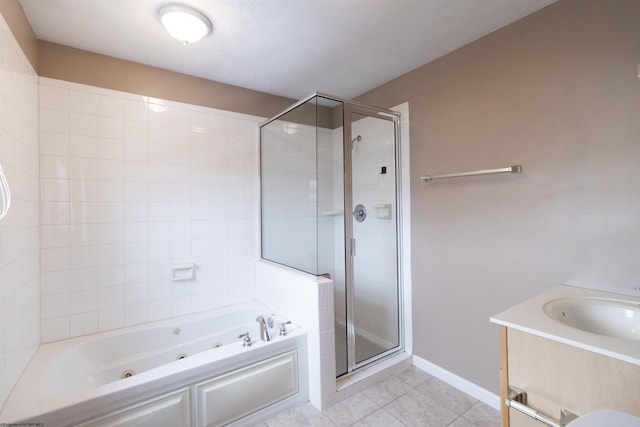 full bathroom with tile patterned flooring, vanity, baseboards, a shower stall, and a tub with jets