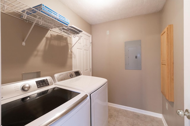 washroom featuring a textured ceiling, laundry area, baseboards, independent washer and dryer, and electric panel