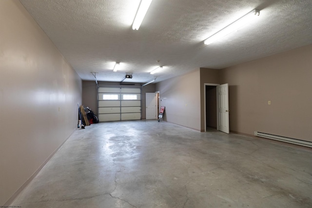 garage with baseboards and a baseboard heating unit