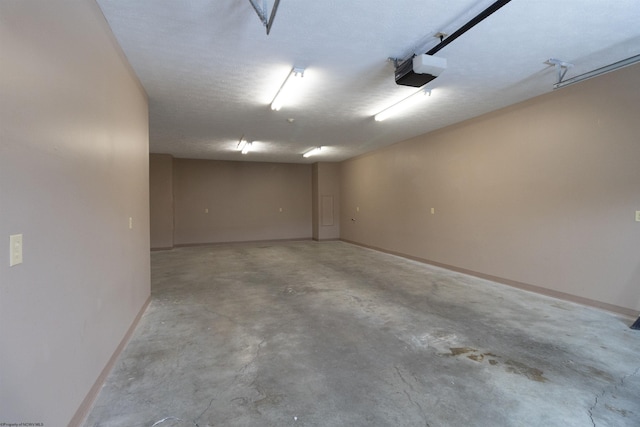 garage featuring baseboards and a garage door opener