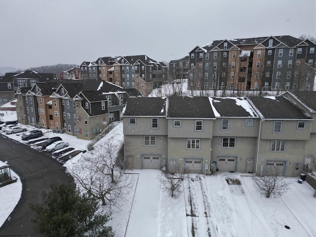 snowy aerial view featuring a residential view