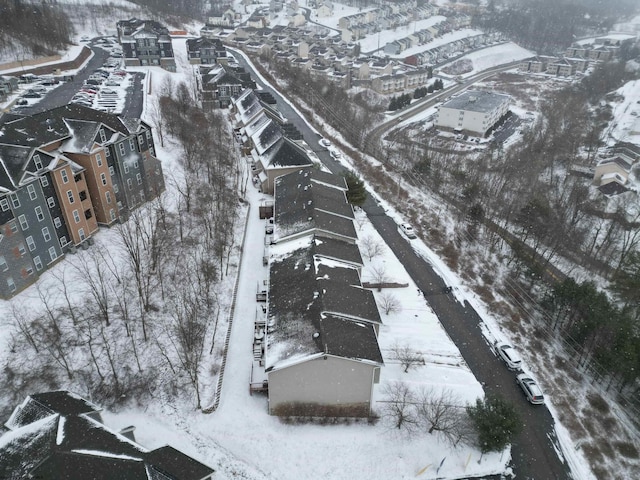 snowy aerial view with a residential view