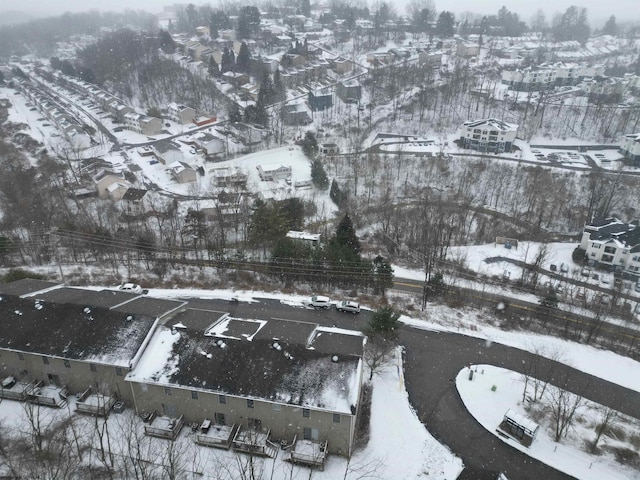 snowy aerial view with a residential view