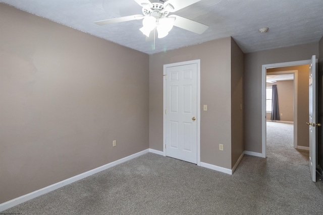 unfurnished bedroom featuring ceiling fan, carpet floors, and baseboards