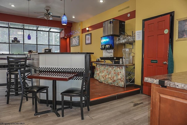 bar with light wood-style floors, pendant lighting, a ceiling fan, and recessed lighting