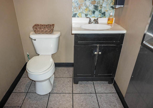 half bath featuring toilet, tile patterned floors, baseboards, and vanity