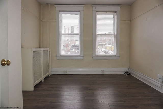 spare room featuring dark wood-type flooring and visible vents