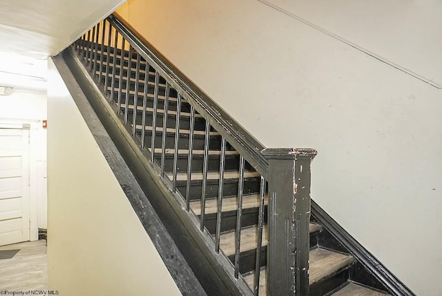 staircase with wood finished floors