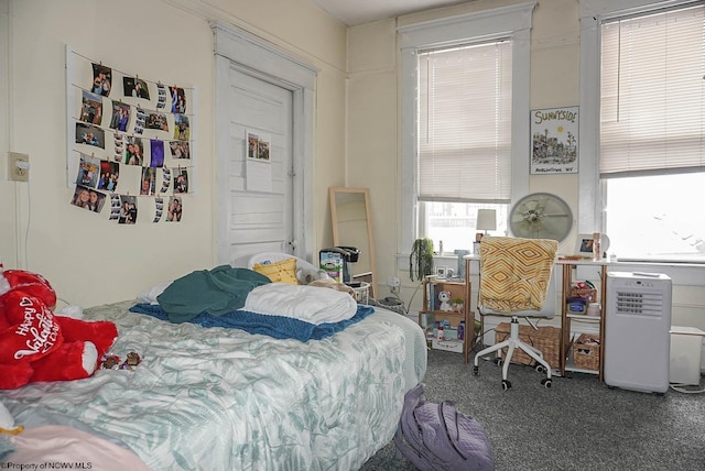 bedroom featuring dark carpet