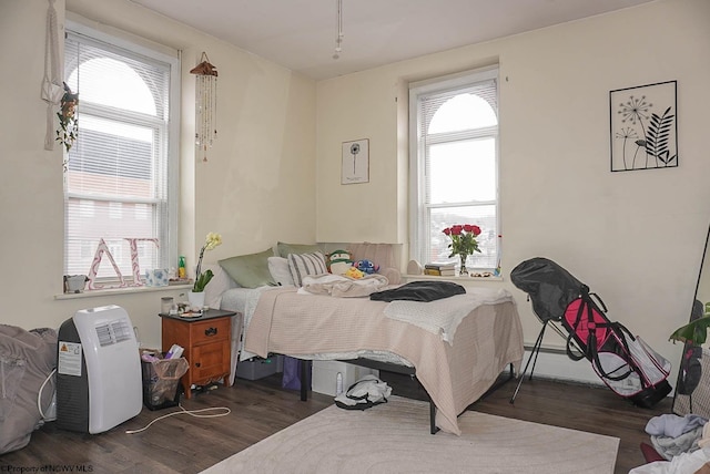 bedroom featuring dark wood finished floors