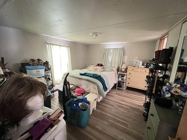 bedroom featuring a textured ceiling and dark wood-type flooring