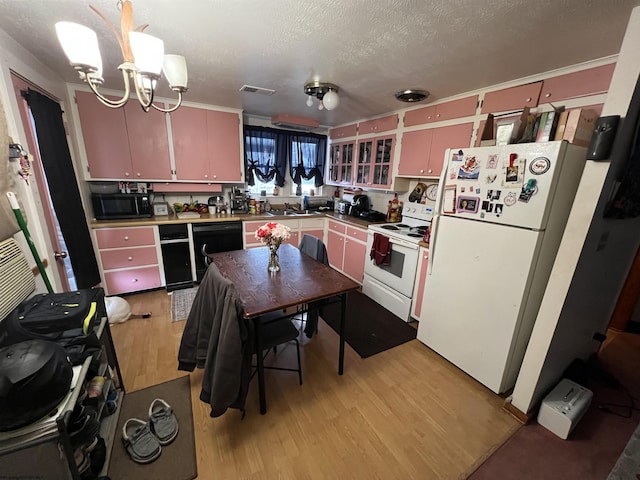 kitchen with visible vents, light wood-style flooring, a textured ceiling, black appliances, and a sink