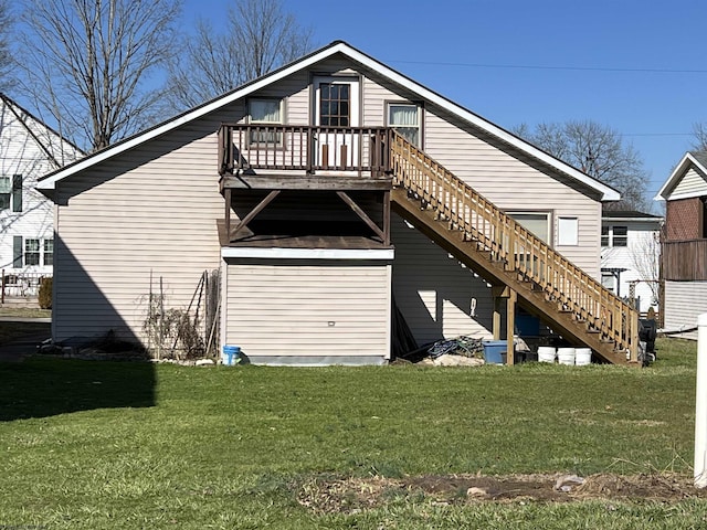 back of property with stairway, a deck, and a lawn