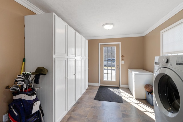 laundry room featuring stone finish flooring, cabinet space, crown molding, and baseboards