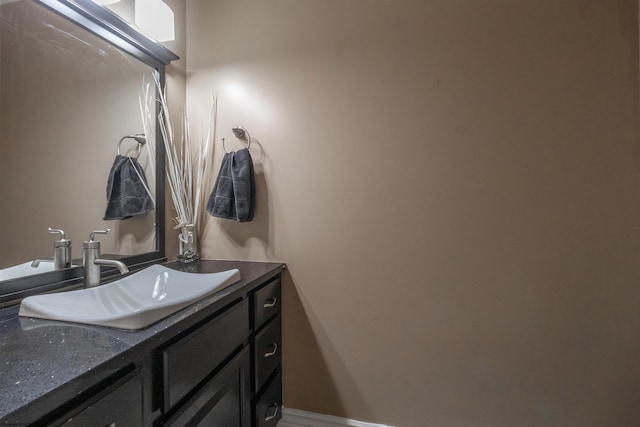 bathroom with vanity and baseboards