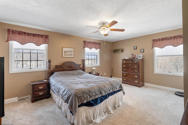 bedroom featuring baseboards, a textured ceiling, and light colored carpet