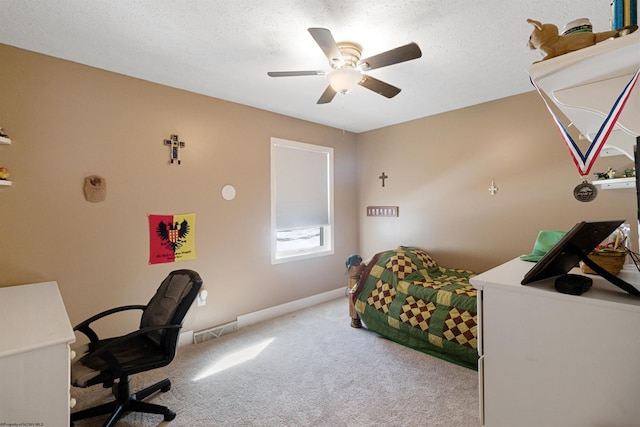 carpeted bedroom featuring ceiling fan, a textured ceiling, visible vents, and baseboards