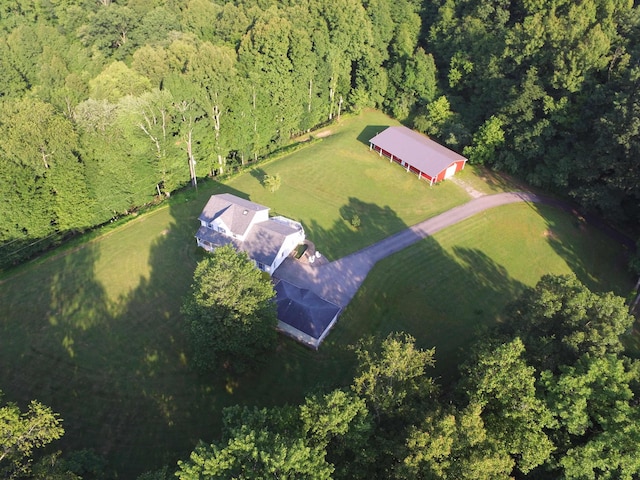 drone / aerial view with a wooded view