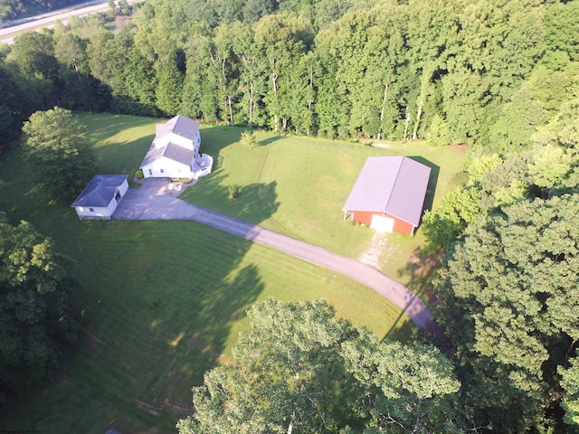 drone / aerial view with a wooded view