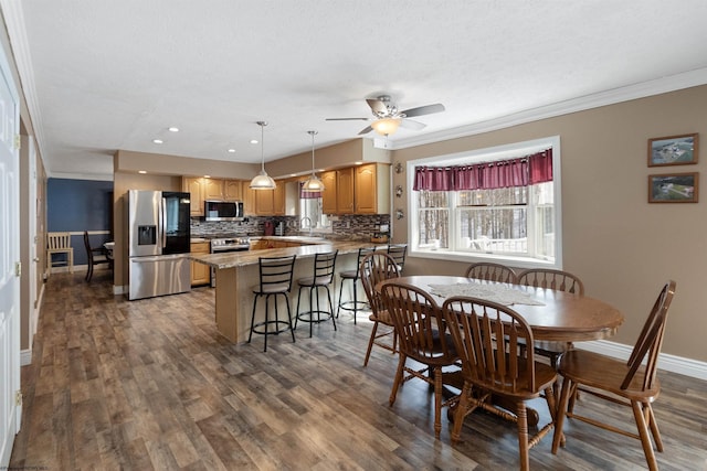 dining room featuring recessed lighting, ornamental molding, a ceiling fan, wood finished floors, and baseboards