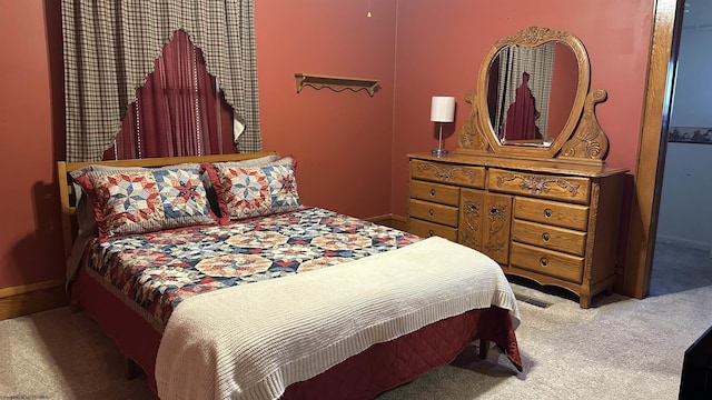 bedroom with carpet floors and baseboards