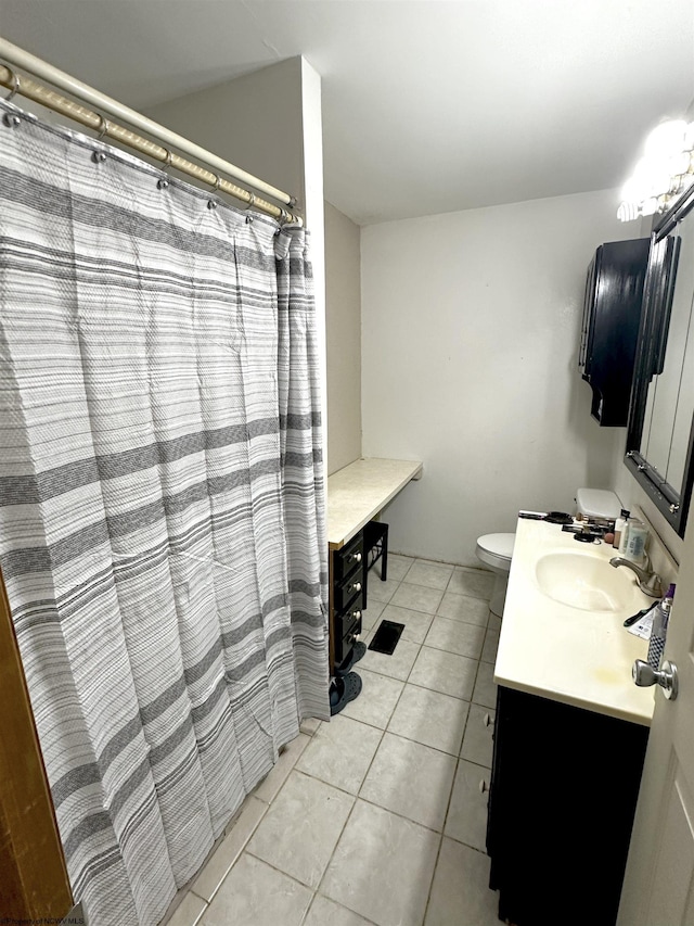 bathroom featuring toilet, tile patterned flooring, and vanity