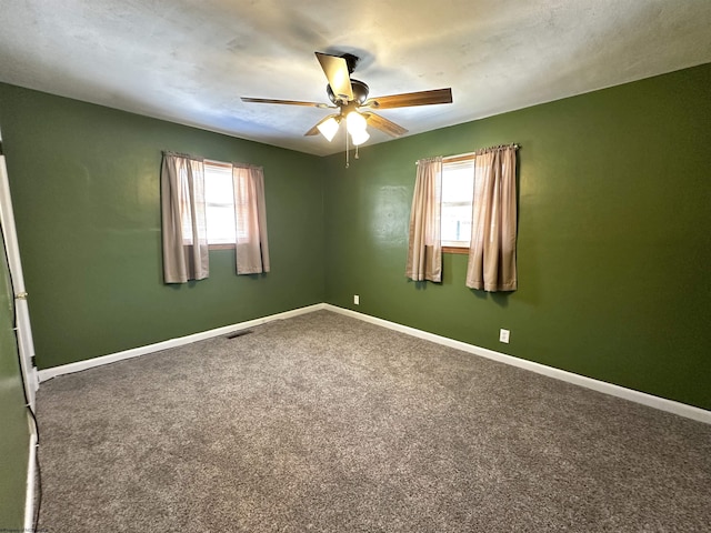 empty room featuring a healthy amount of sunlight, carpet, and baseboards