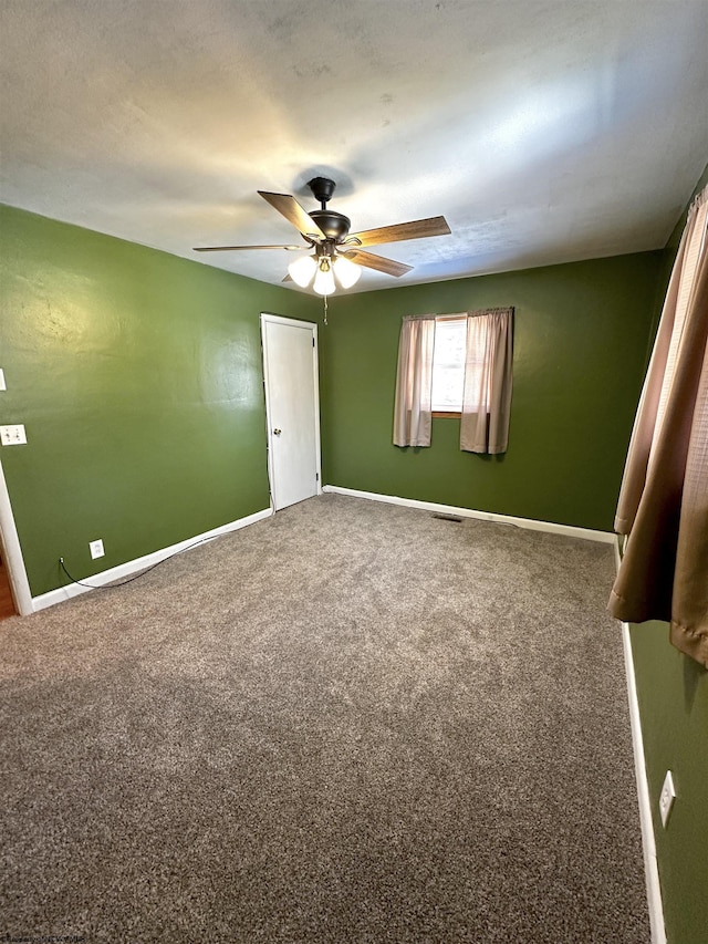 unfurnished bedroom with carpet floors, baseboards, and a ceiling fan