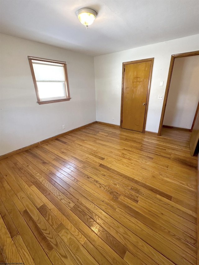 unfurnished bedroom with light wood-style floors and baseboards