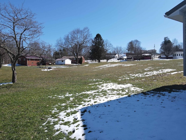 snowy yard featuring a residential view