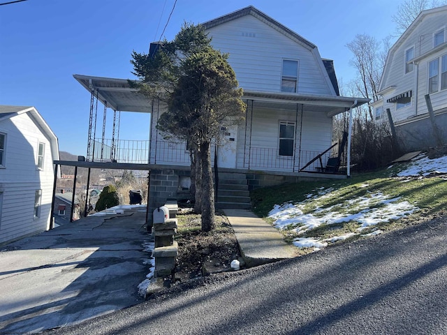 203 Juniper St, Bluefield, WV 24701 - colonial inspired home with covered porch, driveway, and a gambrel roof